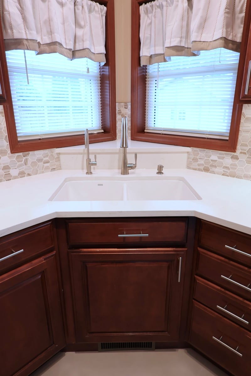 Corner kitchen sink with brushed nickel faucet in Lowell kitchen remodel