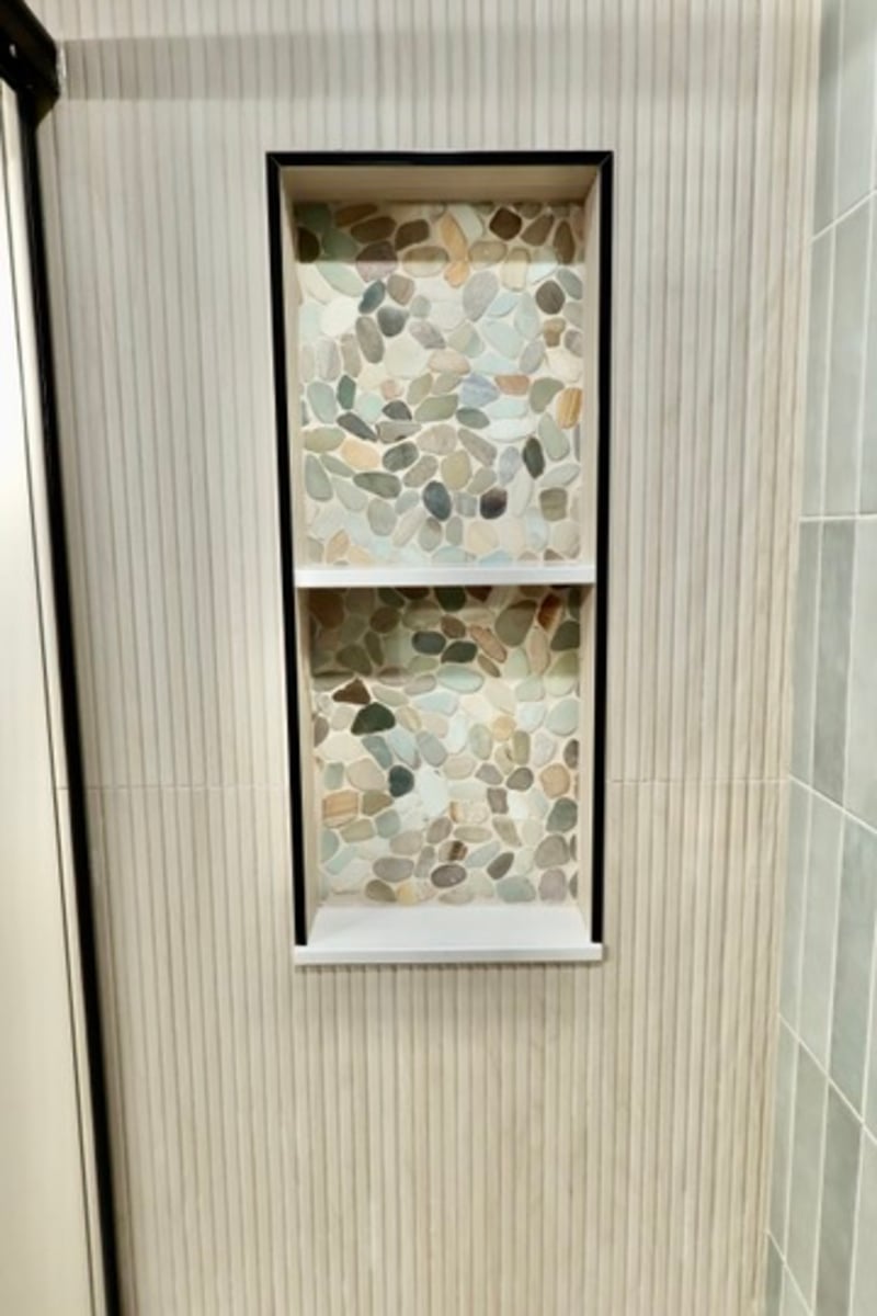 Shower wall niche with pebble tile in Lowell bathroom remodel