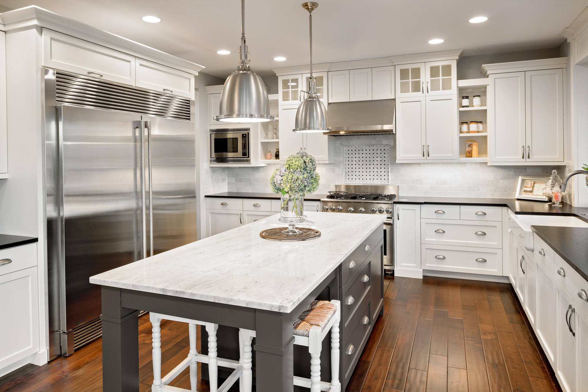 Luxurious kitchen remodel with marble countertops and stainless steel appliances, completed by Clear Contractors in Northwest Indiana