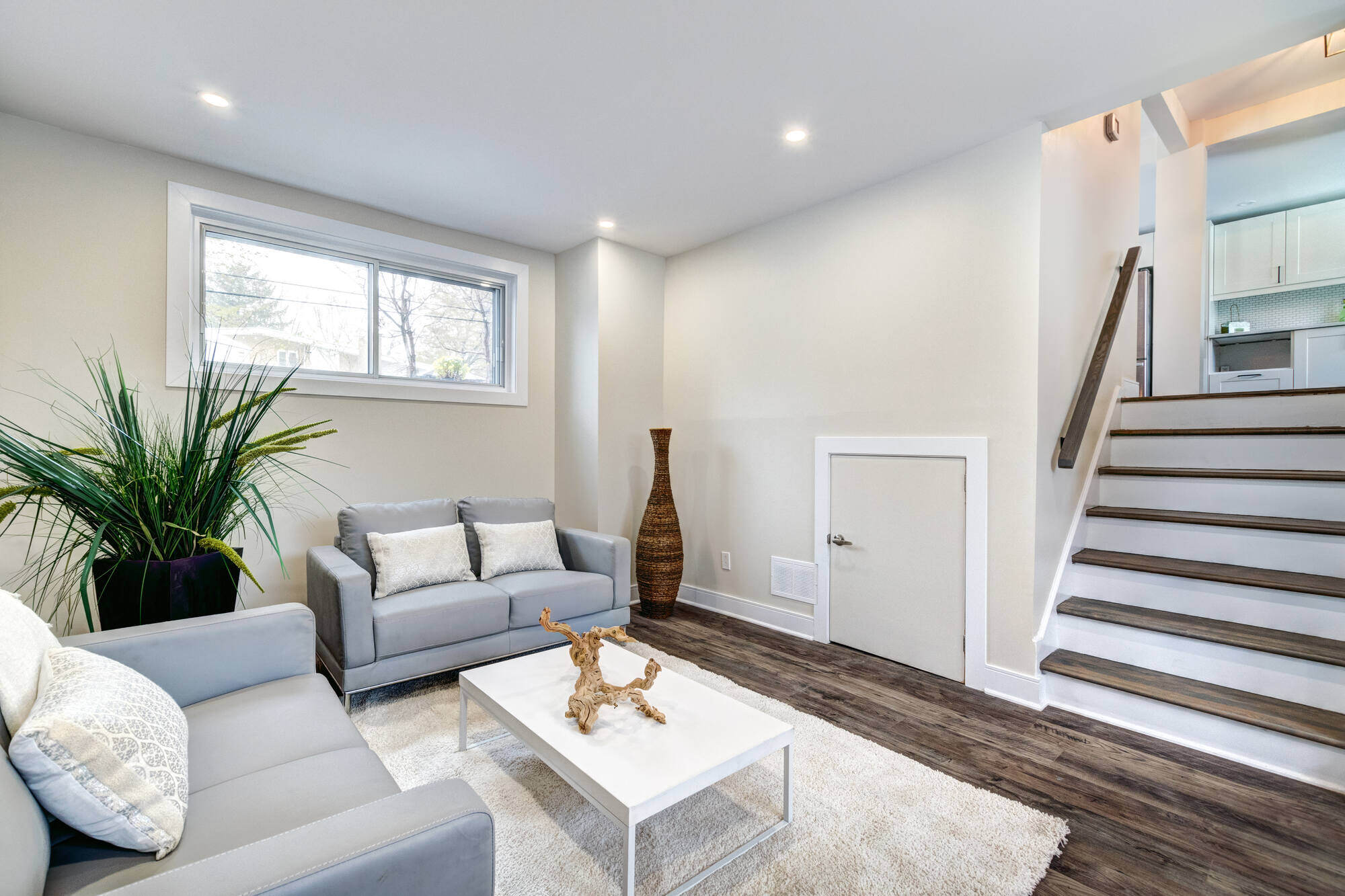 Modern basement living area with neutral tones remodeled by Clear Contractors in Northwest Indiana