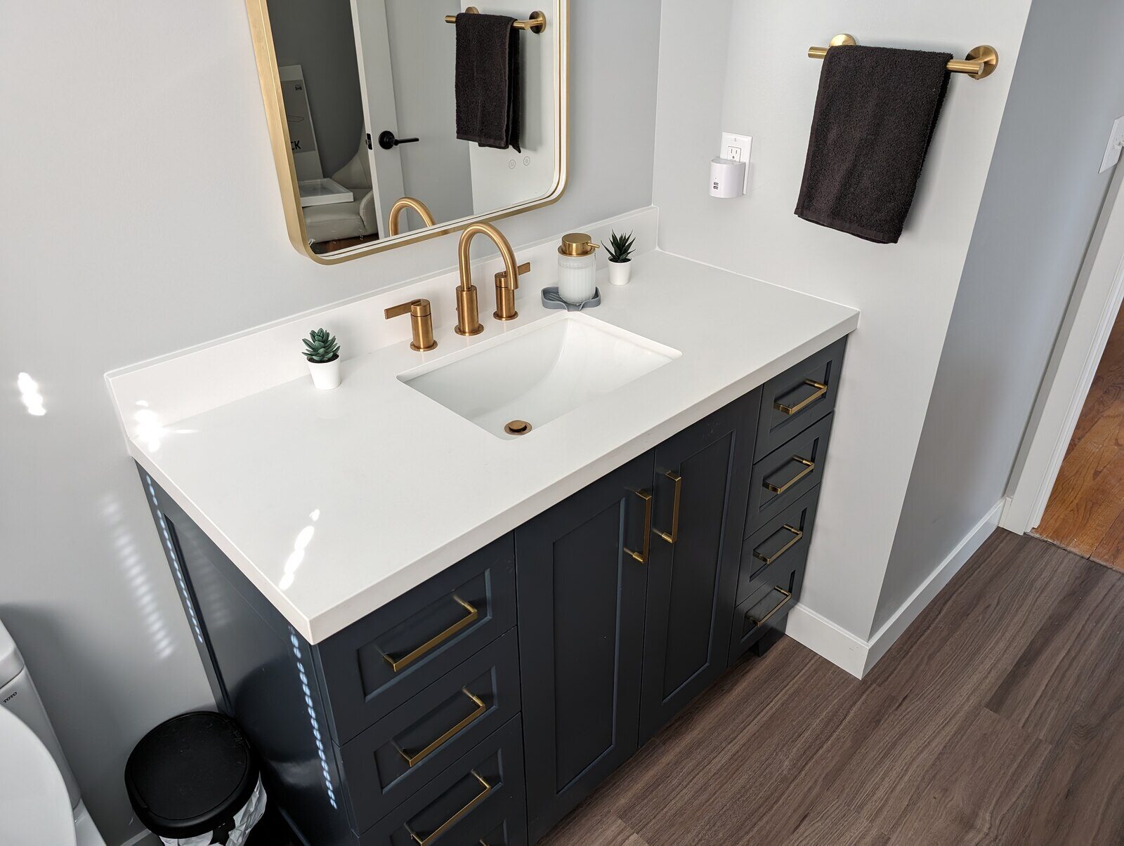 Vanity upgrade with gold fixtures and sleek storage design, Northwest Indiana bathroom remodel